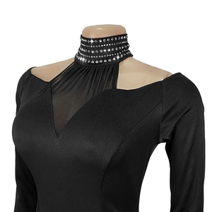 Close-up of elegant black dress featuring rhinestone choker and sheer mesh V-neck detail