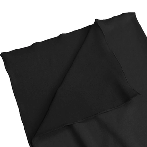 Close-up of black elastic knit fabric texture and neat overlock stitching on the dress