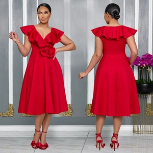 Detail view of red elegant high waist dress with ruffles and large fabric flower decor