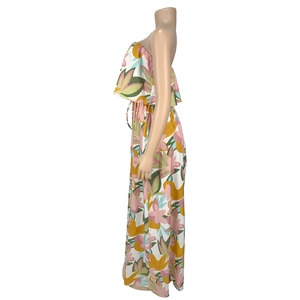 Side view of tropical floral maxi dress featuring tiered ruffles and high front slit