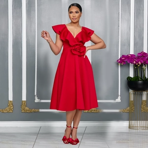 Detail of elegant red deep V-neck dress with ruffle shoulders and floral waist decor