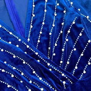 Macro detail of royal blue velvet dress with pearl embroidery and invisible zipper
