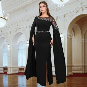 Detail of evening dress featuring mesh patchwork with beads and long cape sleeves