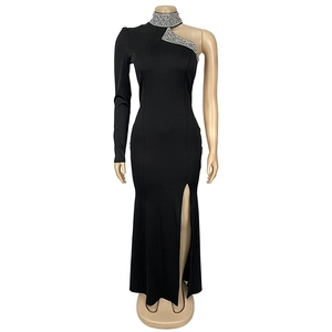 Detail of elegant black dress with shimmering rhinestones and high slit side design