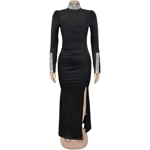 Détail d'une robe noire à manches longues avec col strassé et fente latérale