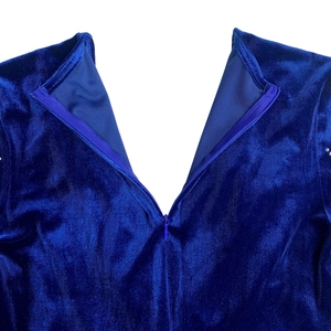 Detail of invisible zipper closure on the back of blue velvet evening dress