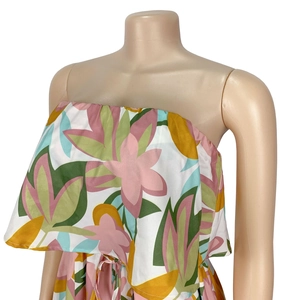 Detail of floral printed off-shoulder dress with layered ruffles and smooth fabric