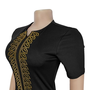 Détail de robe noire élégante avec motifs de strass dorés et encolure en V fendue