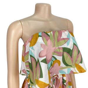 Detail of floral print sleeveless dress with tropical pattern and ruffle bust layer