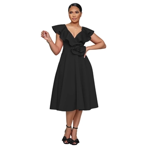 Detail of elegant black V-neck dress with ruffled shoulders and 3D floral waist decor