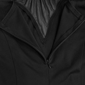 Detail of elegant black dress showing mesh panel stitching and concealed zipper closure
