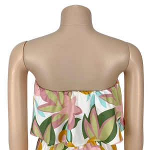 Detailed view of strapless neckline with ruffle trim and tropical floral print pattern