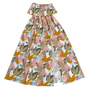 Detailed view of summer dress featuring tropical floral print, ruffles, and front slit