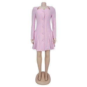 Detail view of pink long sleeve dress featuring front buttons and layered V-neckline