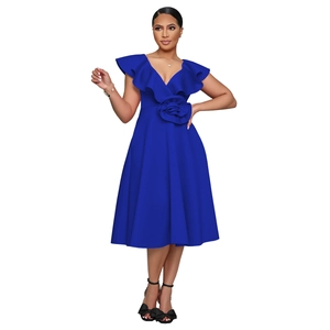 Detail of elegant royal blue V-neck dress featuring ruffles and a handmade 3D floral accent