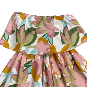 Close-up of ruffled off-shoulder neckline and drawstring waist on floral sleeveless dress