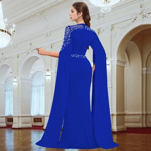 Detail of royal blue evening gown featuring elegant cape sleeves and white pearl beading