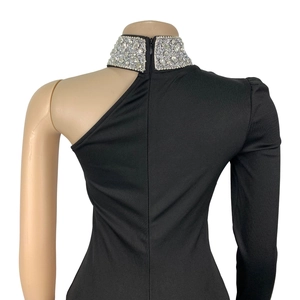 Detailed back view of off-shoulder black top with silver rhinestones and zipper