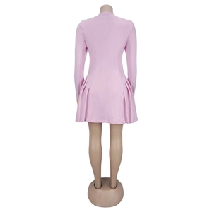Detail view of pink long sleeve mini dress featuring ruffled pleated hem and slim silhouette