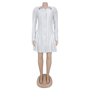 Detail of white dress with deep V-neck, central buttons and ruffled pleats on the hem