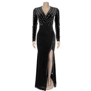 Close-up of sparkling rhinestones and pearl accents on the side slit of this black velvet dress