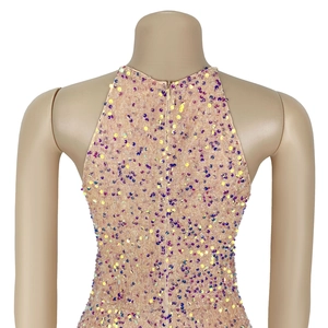Close-up of sparkling purple and gold sequins with invisible back zipper on a formal dress