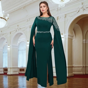 Close-up of deep green evening dress featuring intricate beaded sequins and cape sleeves