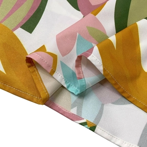 Close-up of high-quality sewing and floral pattern details on this sleeveless dress