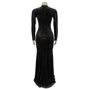 Rear view of long sleeve black velvet maxi dress with white pearl bead sleeve detail