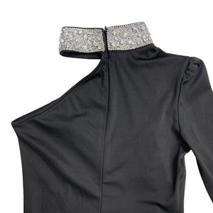 Close-up of elegant off-shoulder black dress featuring a rhinestone-embellished collar