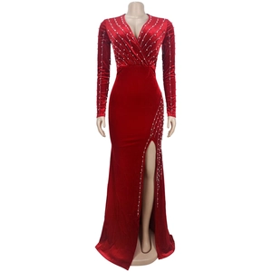 Detail of red velvet gown with elegant pearl embellishments and sexy high side slit