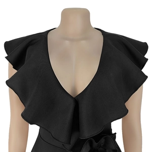 Detail showing deep V-neckline and elegant oversized double ruffles on black evening dress