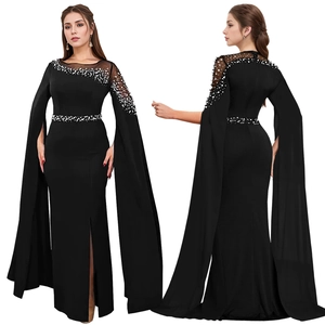 Detail view of black evening gown featuring elegant cape sleeves and white pearl embellishments