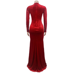 Detail view of the zipper back and pearl beads on the red velvet fishtail dress sleeve