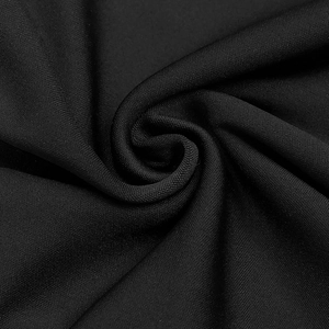Gros plan sur un tissu en maille noire élégant avec texture et plis drapés