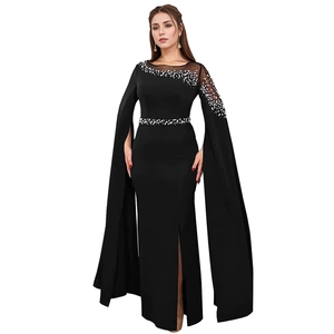 Detail of elegant black evening dress with beaded cape sleeves and high leg slit