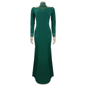 Detail of silver rhinestones on the high neck and mesh panel of the dark green dress
