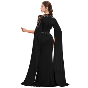 Detail of beaded neckline and flowing cape sleeves on a black mermaid evening gown