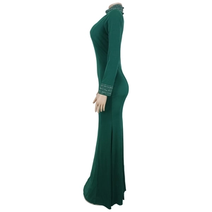 Detail of dark green bodycon dress with rhinestone cuffs and elegant fishtail hemline