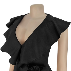Close-up of deep V-neckline and tiered ruffle shoulder details on black elegant dress