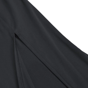 Detail view of high-quality black dress hem featuring a precise slit and fine stitching
