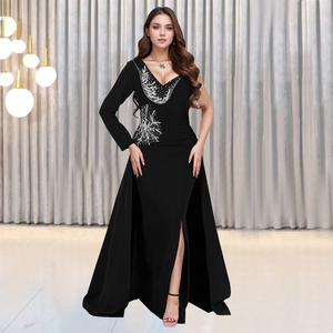 Detail of elegant black evening gown featuring silver sequins and a side high slit design