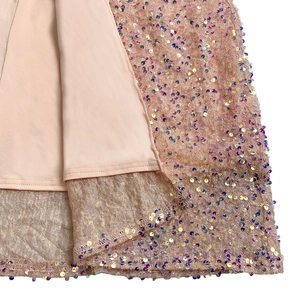 Detailed view of sequin embroidery on light pink dress with fine stitching and lining
