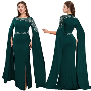 Detail of elegant dark green evening gown with beaded neckline and cape sleeves