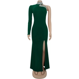 Detail view of dark green dress with silver rhinestone embellishments and high side slit