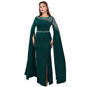 Deep green evening dress with faux pearl embellishments and elegant cape sleeves detail