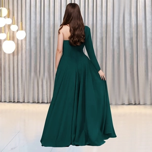 Rear view of elegant dark green one-shoulder evening gown with long sleeve and floor-length hem