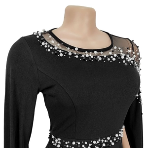 Detail of beaded pearls and crystals on black dress with sheer mesh neckline