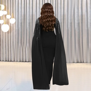 Vue arrière d'une robe de soirée noire élégante avec cape pailletée et coupe longue
