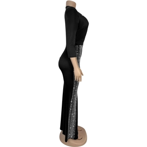 Detail of elegant black slim-fit dress with sparkling silver rhinestones on the side